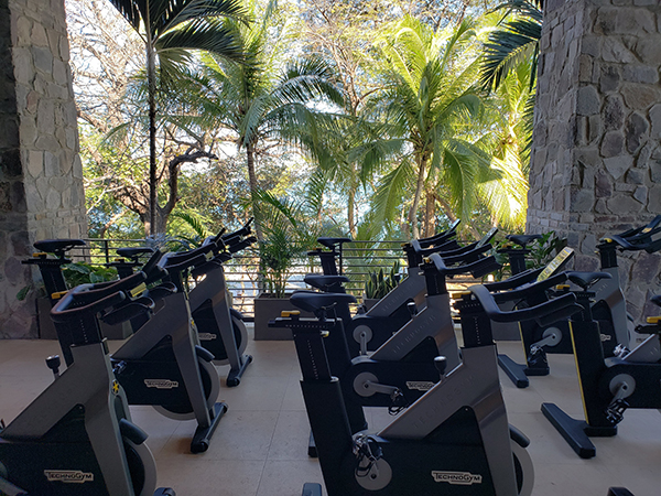 Fitness center at Four Seasons Costa Rica, where you can take spin class with a view of palm trees and the ocean
