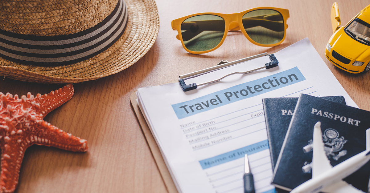 photo of multiple elements representing travel: passports, a model airplane, a model car, sunglasses, a straw hat, a starfish, and a clipboard and pen with a form on it that says "Travel Protection" across the top