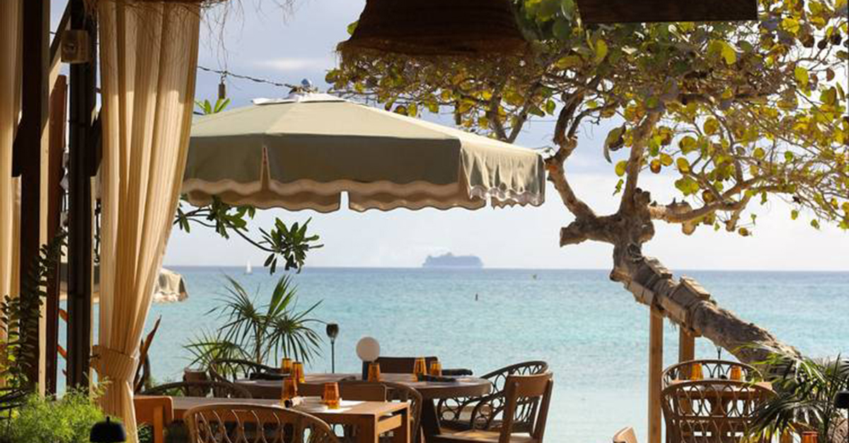 Photo of the Bonny Moon Beach Club, looking from inside the dining room out into the ocean