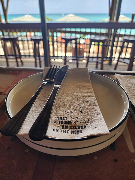 photo of plate and napkin with ocean view from dining room of Bonny Moon Beach Club 